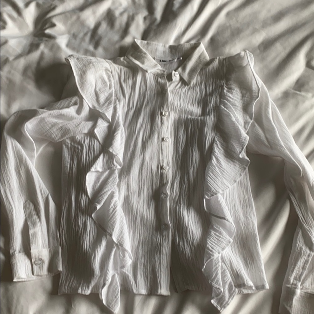 White button up blouse with ruffle sleeves